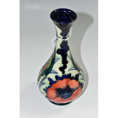 346 - A 1996 MOORCROFT POTTERY  BALUSTER VASE, 'Poppy' pattern on a dark blue ground, designed by Rachel B... 