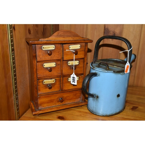 389 - A SMALL SPICE CABINET AND A BLUE ENAMEL HOT WATER POT, comprising a seven drawer spice cabinet, six ... 