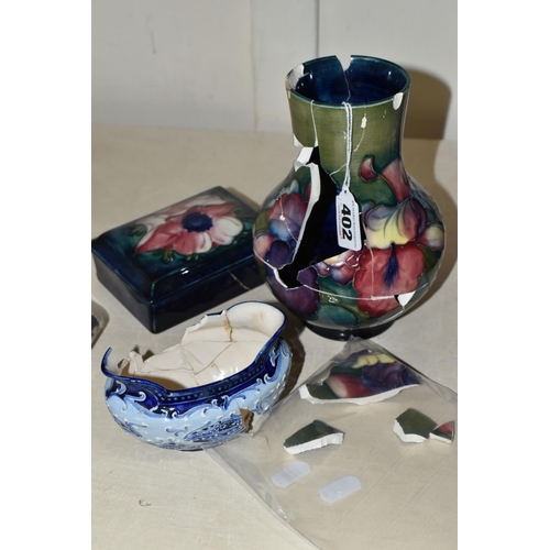 402 - TWO PIECES OF MOORCROFT POTTERY AND A MACINTYRE SUGAR BOWL, all in very poor condition, the Moorcrof... 