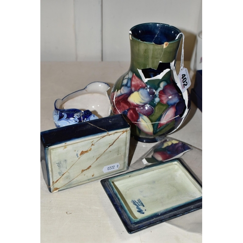 402 - TWO PIECES OF MOORCROFT POTTERY AND A MACINTYRE SUGAR BOWL, all in very poor condition, the Moorcrof... 