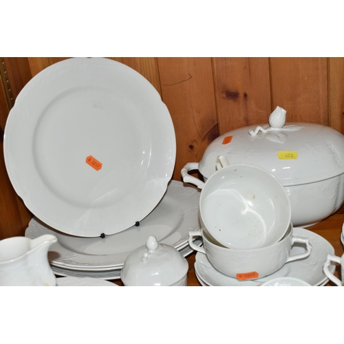 458 - A QUANTITY OF WHITE KAISER 'DUBERRY' DESIGN DINNERWARE, comprising two covered tureens (one has a cr... 