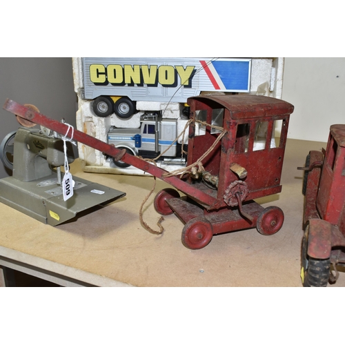 509 - TWO TRI-ANG PLAYWORN RED TRUCKS WITH HARD RUBBER TYRES, A SIMILAR RED PAINTED CRANE, A CHILD'S VULCA... 