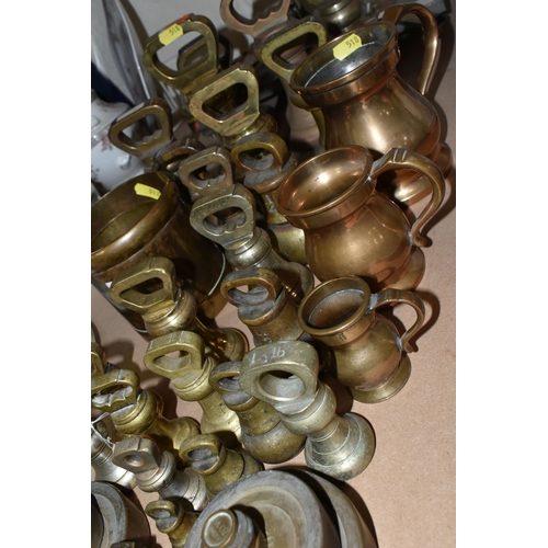 518 - A QUANTITY OF BRASS & METALWARE comprising twenty-four graduated brass bell weights, five metal meas... 