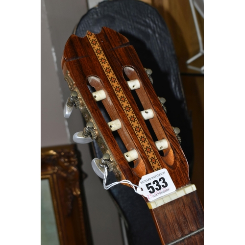 533 - AN EPIPHONE ACOUSTIC GUITAR, made in Japan, with a hard case, solid cedar top, mahogany back and sid... 