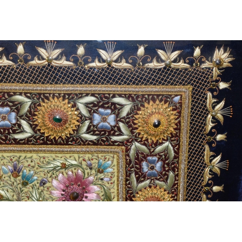 543 - A 20TH CENTURY RAISED NEEDLEWORK PICTURE, depicting still life flower scene to the centre panel bord... 