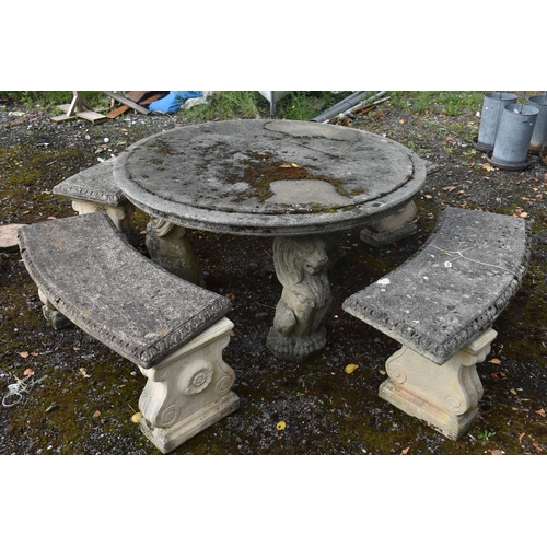 1019 - A RECONSTITUTED STONE FIVE PIECE GARDEN SUITE, comprising a circular table that rests on three seate... 