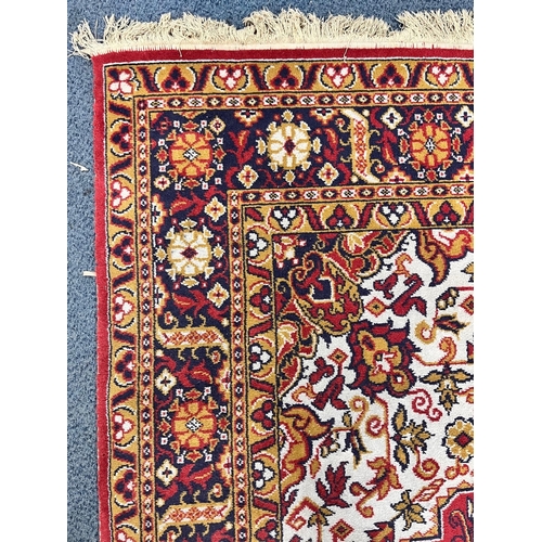 1198 - A LARGE WOOLLEN PERSIAN FLORAL PATTERNED RUG, with a red and cream field, 360cm x 250cm (condition r... 