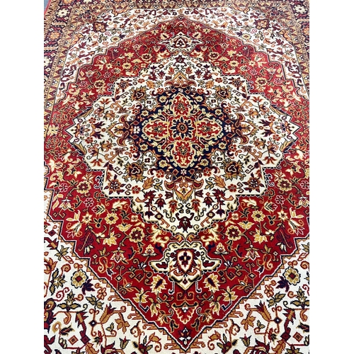 1198 - A LARGE WOOLLEN PERSIAN FLORAL PATTERNED RUG, with a red and cream field, 360cm x 250cm (condition r... 