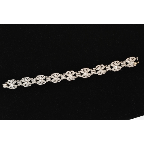 33 - AN ART DECO STYLE DIAMOND BRACELET, nine white metal panels, each set with a single bezel set round ... 