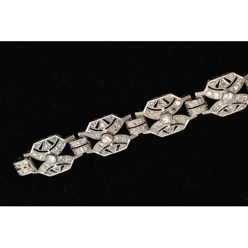 33 - AN ART DECO STYLE DIAMOND BRACELET, nine white metal panels, each set with a single bezel set round ... 