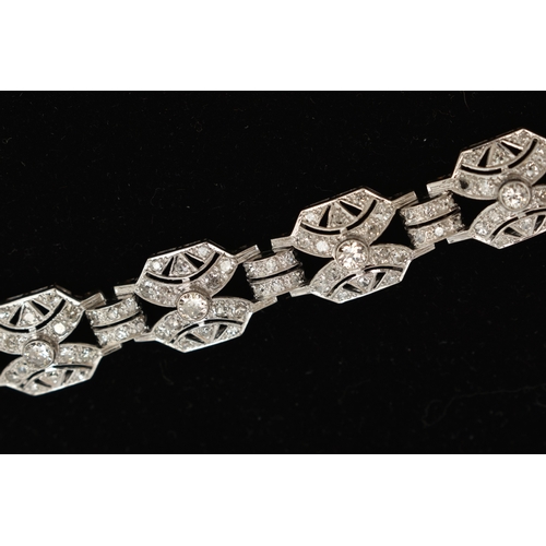 33 - AN ART DECO STYLE DIAMOND BRACELET, nine white metal panels, each set with a single bezel set round ... 