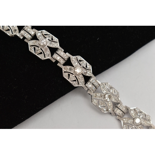 33 - AN ART DECO STYLE DIAMOND BRACELET, nine white metal panels, each set with a single bezel set round ... 