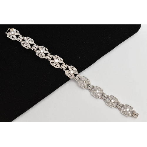 33 - AN ART DECO STYLE DIAMOND BRACELET, nine white metal panels, each set with a single bezel set round ... 