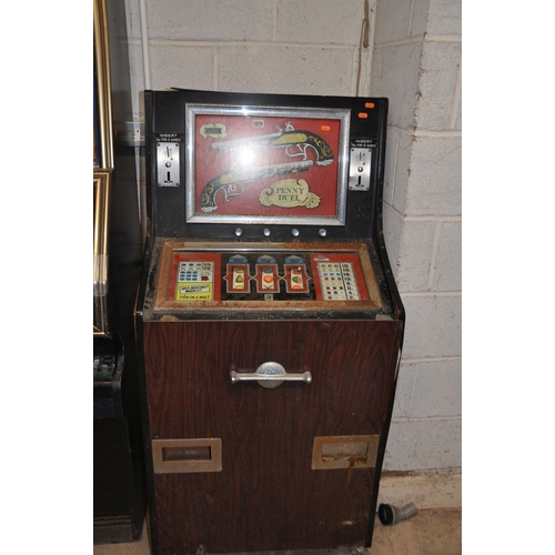 1070 - A VINTAGE 'LEEDS' SLOT MACHINE with 'Penny Duel' graphics, width 67cm x height 140cm (untested and m... 