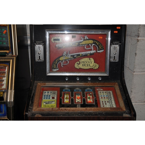 1070 - A VINTAGE 'LEEDS' SLOT MACHINE with 'Penny Duel' graphics, width 67cm x height 140cm (untested and m... 