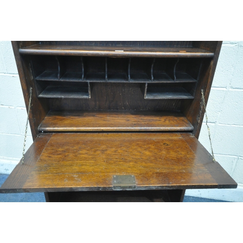 1212 - AN EARLY 20TH CENTURY OAK STUDENT BUREAU, width 76cm x depth 25cm, height 153cm, and a two door wash... 