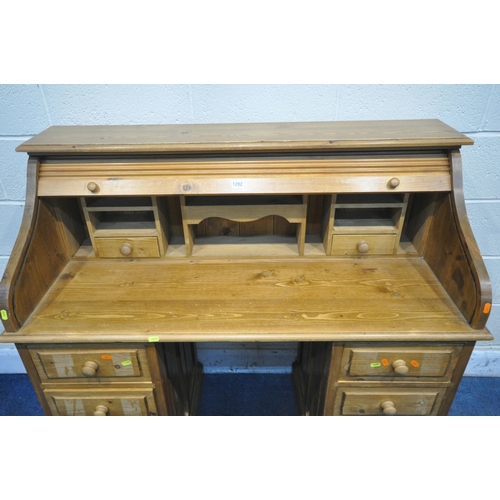 1292 - A MODERN PINE TWIN PEDESTAL ROLL TOP DESK, with a fitted interior, each pedestal with four drawers, ... 