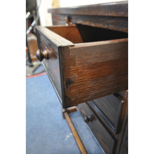 1324 - A 20TH CENTURY OAK SIDE TABLE, with three drawers and single cupboard door, width 65cm x depth 38cm ... 