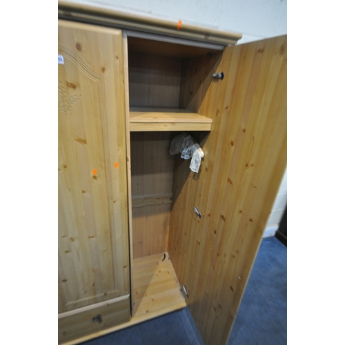 1325 - A MODERN PINE EFFECT THREE DOOR WARDROBE, with a single drawer, width 134cm x depth 53cm x height 18... 