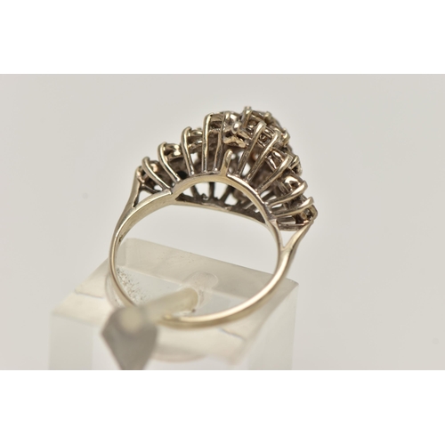 10 - A WHITE METAL ABSTRACT DIAMOND RING, raised marquise shape, set with a central round brilliant cut d... 