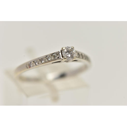 15 - A 9CT WHITE GOLD DIAMOND RING, set with a central four claw set, round brilliant cut diamond, estima... 