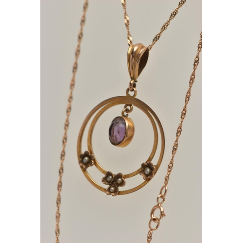 16 - AN EARLY 20TH CENTURY YELLOW METAL LAVALIER PENDANT NECKLACE, the pendant of an open work circular f... 