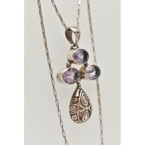 28 - A WHITE METAL GEM SET PENDANT NECKLACE, the pendant set with three oval cut amethysts, with a textur... 