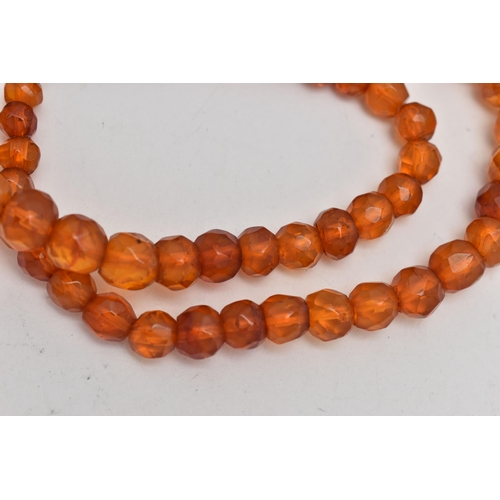 29 - A GRADUATED FACETED COPAL AMBER BEAD NECKLACE, fitted with a white metal magnetic clasp, length 440m... 