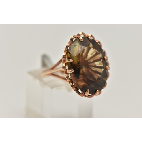 3 - A LARGE 9CT GOLD SMOKY QUARTZ DRESS RING, oval cut smoky quartz, double claw set within an open work... 