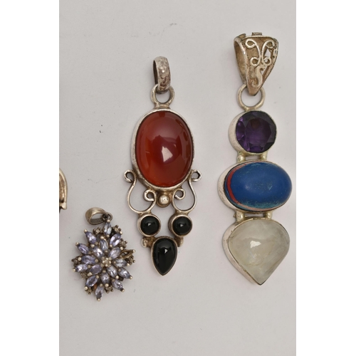 35 - FIVE WHITE METAL STATEMENT PENDANTS, various designs, set with stones to include carnelian, moonston... 