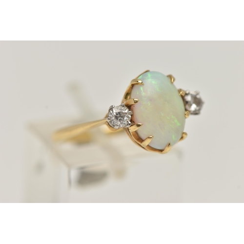 4 - A YELLOW METAL OPAL AND DIAMOND RING, centring on an oval cut opal cabochon, in a nine claw setting,... 