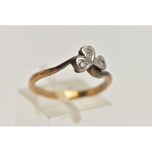 49 - A TREFOIL DIAMOND RING, three single cut diamonds, set in a clover design mount leading on to a yell... 