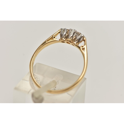 53 - A THREE STONE DIAMOND RING, three old cut diamonds, prong set in white metal, leading on to a yellow... 