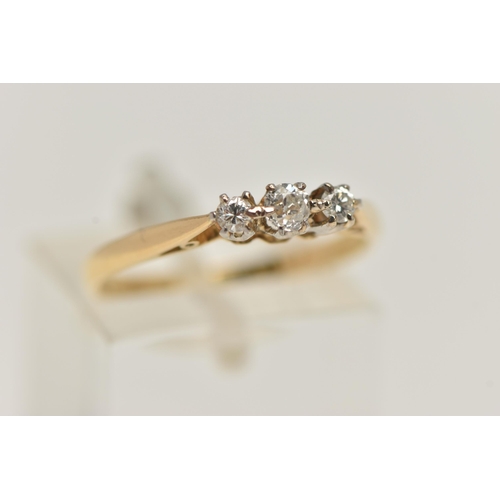 53 - A THREE STONE DIAMOND RING, three old cut diamonds, prong set in white metal, leading on to a yellow... 