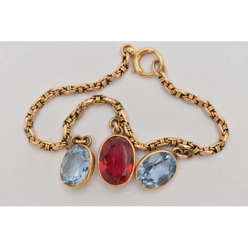 60 - A YELLOW METAL GEM SET BRACELET, two oval cut synthetic blue spinel's and an oval cut synthetic ruby... 