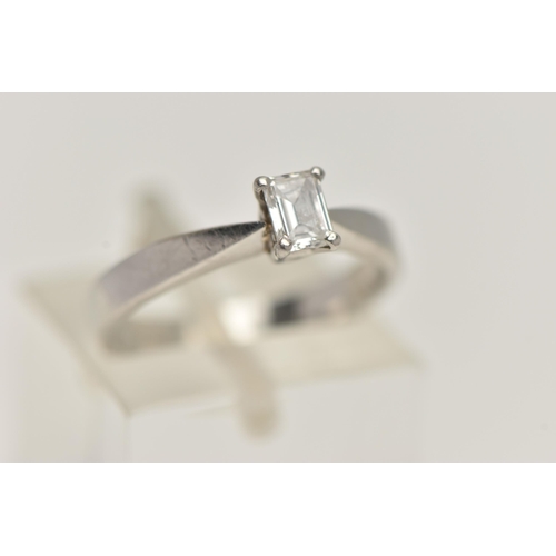 66 - A PLATINUM SINGLE STONE DIAMOND RING, emerald cut diamond prong set in platinum, leading on to a pin... 