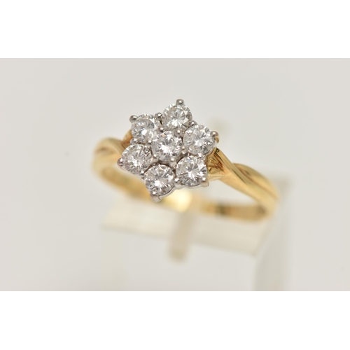 67 - A 18CT GOLD DIAMOND CLUSTER RING, seven round brilliant cut diamonds, prong set in white gold, appro... 