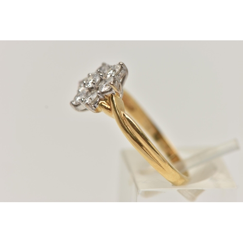 67 - A 18CT GOLD DIAMOND CLUSTER RING, seven round brilliant cut diamonds, prong set in white gold, appro... 