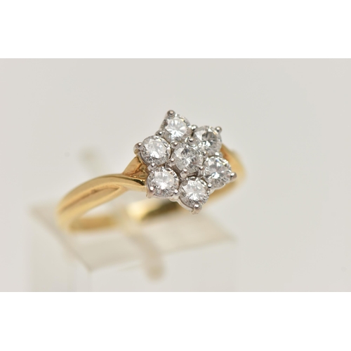 67 - A 18CT GOLD DIAMOND CLUSTER RING, seven round brilliant cut diamonds, prong set in white gold, appro... 