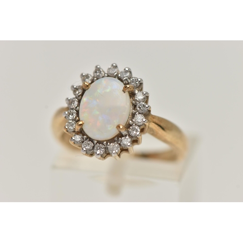 68 - A 9CT GOLD OPAL AND DIAMOND CLUSTER RING, oval opal prong set with a surround of eighteen round bril... 