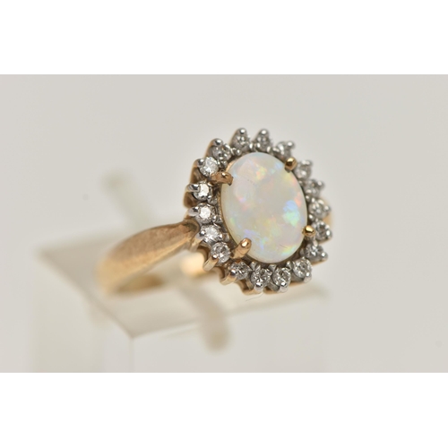 68 - A 9CT GOLD OPAL AND DIAMOND CLUSTER RING, oval opal prong set with a surround of eighteen round bril... 