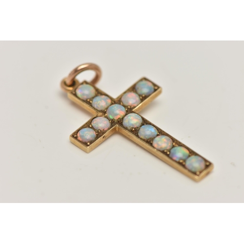 7 - A YELLOW METAL OPAL CROSS PENDANT, set with twelve circular cut opal cabochons, to a polished mount,... 