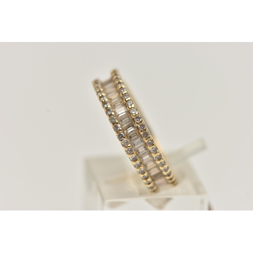 8 - A YELLOW METAL DIAMOND BAND RING, set with a central row of baguette cut diamonds, between two rows ... 