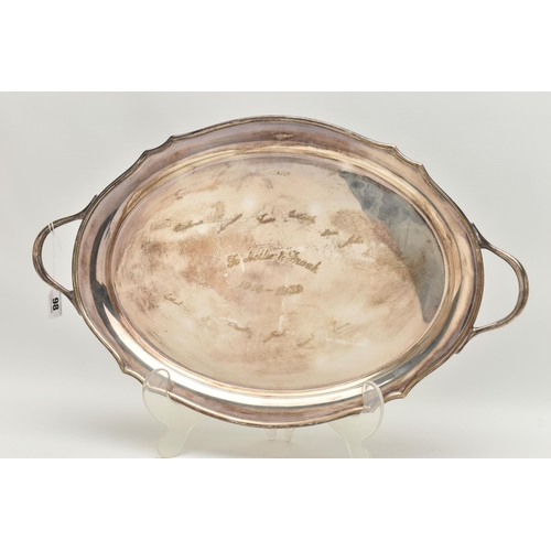 98 - A GEORGE VI SILVER OVAL TWIN HANDLED TRAY WITH WAVY EDGE, the front inscribed with presentation insc... 