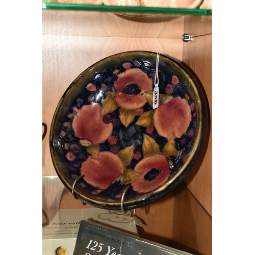 356 - A WILLIAM MOORCROFT SHALLOW FRUIT BOWL DECORATED WITH THE POMEGRANATE PATTERN ON A BLUE / BROWN GREE... 