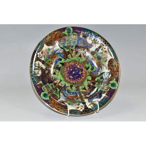 371 - DAISY MAKEIG-JONES FOR WEDGWOOD, A FAIRYLAND LUSTRE SHALLOW BOWL, the interior decorated in The Gard... 