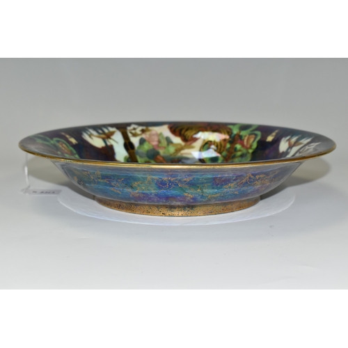 371 - DAISY MAKEIG-JONES FOR WEDGWOOD, A FAIRYLAND LUSTRE SHALLOW BOWL, the interior decorated in The Gard... 