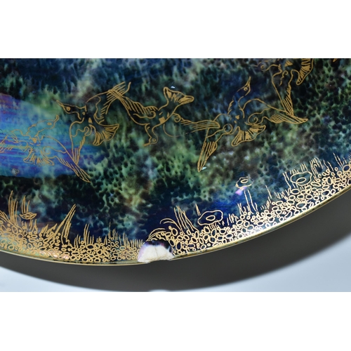 371 - DAISY MAKEIG-JONES FOR WEDGWOOD, A FAIRYLAND LUSTRE SHALLOW BOWL, the interior decorated in The Gard... 