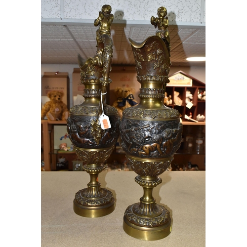 429 - A PAIR OF BRONZED BRASS EWERS, decorated with a bacchanalian design, Putti and grapevine, height 59c... 