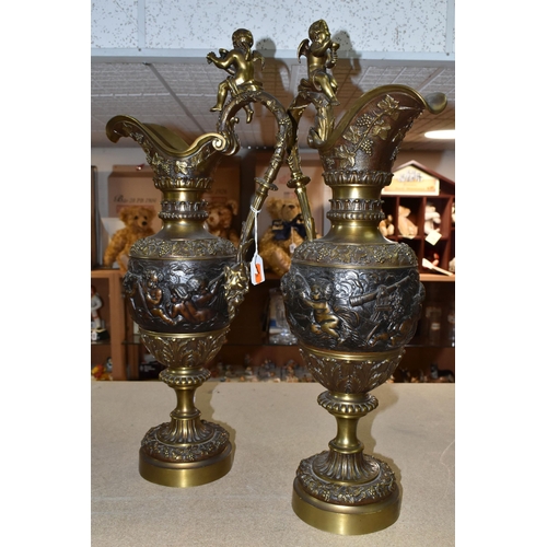 429 - A PAIR OF BRONZED BRASS EWERS, decorated with a bacchanalian design, Putti and grapevine, height 59c... 